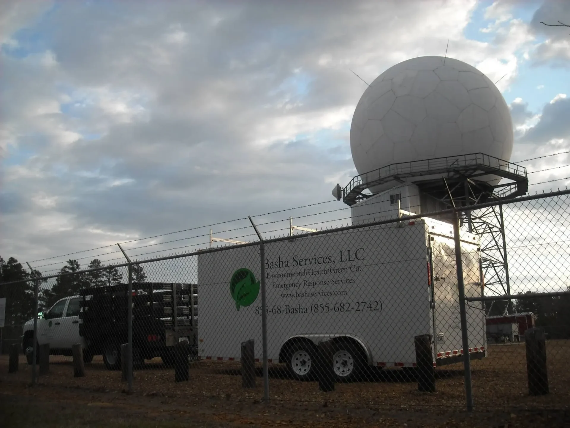 A truck is parked in front of a large dome.